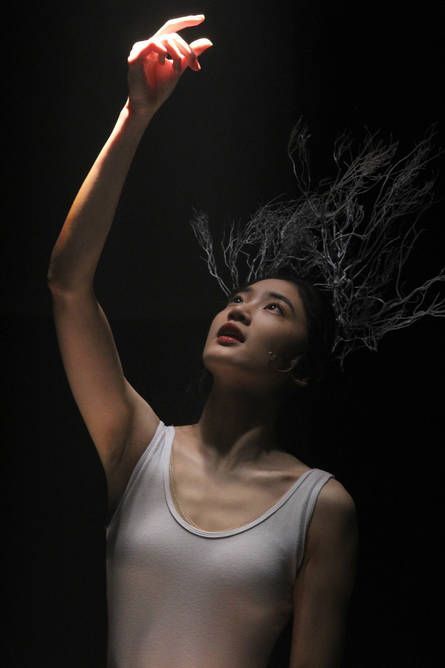 Dancer in white leotard with headdress